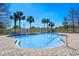 Community pool with lounge area surrounded by palm trees at 6336 Buford St # 706, Orlando, FL 32835