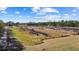 A high-angle perspective of land featuring rows of crops, framed by a vast sky with scattered clouds at 8122 Pine Island Rd, Clermont, FL 34711