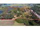 Expansive property featuring diverse landscaping, waterways and agricultural fields with a red boundary line at 8122 Pine Island Rd, Clermont, FL 34711