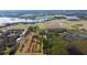 Aerial view of the property featuring a beautiful lake and a serene landscape under a partly cloudy sky at 8122 Pine Island Rd, Clermont, FL 34711