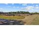 Exterior view of the property with agriculture plots under a sunny sky with scattered clouds at 8122 Pine Island Rd, Clermont, FL 34711