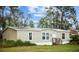 View of home with neutral siding, front steps, and a well-kept lawn at 8122 Pine Island Rd, Clermont, FL 34711