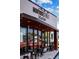 The entrance to Montrose Street Market is framed by floor to ceiling windows and outdoor seating on the sidewalk at 8122 Pine Island Rd, Clermont, FL 34711