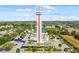 Aerial view of the iconic Clermont observation tower surrounded by lush greenery and ample parking at 8122 Pine Island Rd, Clermont, FL 34711