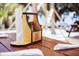 Picnic table featuring a wooden caddy containing condiments and napkins near the sandy beach at the Salt Shack on the Lake restaurant at 8122 Pine Island Rd, Clermont, FL 34711