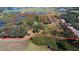 Expansive aerial view of a property with marked boundaries, lush greenery, multiple ponds and cultivated fields at 8122 Pine Island Rd, Clermont, FL 34711