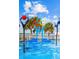 Fun splash pad featuring interactive water elements, palm trees, and colorful fixtures for cooling fun at 8122 Pine Island Rd, Clermont, FL 34711