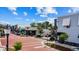 Quaint commercial street view with brick crosswalks, manicured landscaping, and a variety of businesses under a bright sky at 8122 Pine Island Rd, Clermont, FL 34711