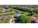 An aerial shot of a home backing onto a picturesque pond, surrounded by mature trees and green lawns at 8155 Brocatel Ct, Orlando, FL 32822