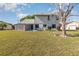 Backyard view including table and chairs, a shed, and a spacious yard at 8155 Brocatel Ct, Orlando, FL 32822