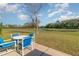 This backyard view includes a table with 4 chairs and a waterfront view at 8155 Brocatel Ct, Orlando, FL 32822