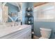 Bright bathroom with a vanity, marble countertop, and decorative mirror at 8155 Brocatel Ct, Orlando, FL 32822