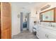 Bright bathroom with a marble-look countertop, vanity and view into bedroom at 8155 Brocatel Ct, Orlando, FL 32822