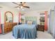 Comfortable bedroom featuring a ceiling fan, two windows with a view, and matching nightstands at 8155 Brocatel Ct, Orlando, FL 32822