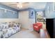 Cozy bedroom featuring a daybed, chair, and a decorative wall panel at 8155 Brocatel Ct, Orlando, FL 32822