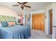 This bedroom includes a full closet, exterior view and attached bathroom at 8155 Brocatel Ct, Orlando, FL 32822