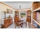 Well-lit dining room with a round table and a window overlooking the backyard at 8155 Brocatel Ct, Orlando, FL 32822