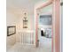 Hallway showcasing a view into a bedroom with a floral sofa and blue walls at 8155 Brocatel Ct, Orlando, FL 32822