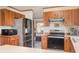 Well-lit kitchen featuring stainless steel appliances and wood cabinets at 8155 Brocatel Ct, Orlando, FL 32822