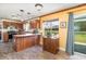 Kitchen area featuring wood cabinets, an island, and a large window with a scenic view at 8155 Brocatel Ct, Orlando, FL 32822