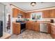 Functional kitchen featuring stainless steel appliances and wood cabinets at 8155 Brocatel Ct, Orlando, FL 32822