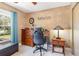 Home office featuring a desk, chair, and window overlooking the landscape at 8155 Brocatel Ct, Orlando, FL 32822