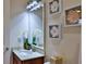 Bathroom featuring flower accents, marble countertop and decorative mirror at 842 Aldenham Ln, Ormond Beach, FL 32174