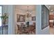 Formal dining room featuring a glass-top table with seating for six and a decorative chandelier for elegant dinners at 842 Aldenham Ln, Ormond Beach, FL 32174