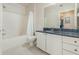 Bright bathroom with white cabinets, granite countertop, and shower-tub combination at 911 N Orange Ave # 110, Orlando, FL 32801