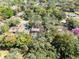 Aerial view of property showcasing mature trees, landscaping, and a screened-in pool area at 916 Puma Trl, Winter Springs, FL 32708