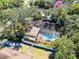 Overhead view of a home featuring a screened-in pool and surrounding landscaping at 916 Puma Trl, Winter Springs, FL 32708