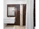 Stylish bathroom with a walk-in shower, featuring decorative brown tile and modern vanity at 916 Puma Trl, Winter Springs, FL 32708