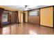 Bright bedroom with hardwood floors features french doors to the backyard pool at 916 Puma Trl, Winter Springs, FL 32708