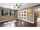 Bright bedroom with hardwood floors, windows with shutters, and white closet doors at 916 Puma Trl, Winter Springs, FL 32708