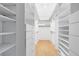 Walk-in closet with custom shelving and drawers provides ample storage space at 916 Puma Trl, Winter Springs, FL 32708