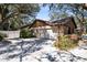 Charming home exterior features a two-car garage, brick accents, and attractive landscaping at 916 Puma Trl, Winter Springs, FL 32708