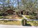 Inviting home front yard with well-manicured lawn, mature trees, and brick mailbox at 916 Puma Trl, Winter Springs, FL 32708