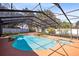 An overhead view of screened-in pool and jacuzzi with lush landscaping at 916 Puma Trl, Winter Springs, FL 32708