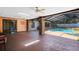 Covered patio and pool with a brick columns and dark tile flooring at 916 Puma Trl, Winter Springs, FL 32708