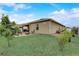 Expansive backyard with a cozy patio area, perfect for outdoor entertaining and enjoying the well-maintained lawn at 10139 Grande Loop, Clermont, FL 34711