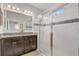 Bathroom with a glass-enclosed shower, double vanity, and modern finishes offers a spa-like experience at 10139 Grande Loop, Clermont, FL 34711