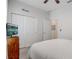 Comfortable bedroom features a queen bed, wardrobe, and view to another room, creating a peaceful retreat at 10139 Grande Loop, Clermont, FL 34711