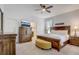 Beautiful bedroom features a wooden bed frame, complemented by neutral decor and natural light, creating a serene retreat at 10139 Grande Loop, Clermont, FL 34711