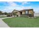 Beautiful home with manicured lawn, a two-car garage, and vibrant landscaping at 10139 Grande Loop, Clermont, FL 34711