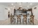 Modern kitchen with stainless steel appliances, granite countertops, dark wood cabinets, and eat-in island at 10139 Grande Loop, Clermont, FL 34711