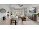 Cozy living room featuring tile floors, neutral decor, and a large window at 10139 Grande Loop, Clermont, FL 34711