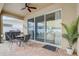 Covered patio with outdoor seating and a sliding glass door, perfect for enjoying the fresh air and entertaining guests at 10139 Grande Loop, Clermont, FL 34711