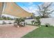 Charming patio with a large shade sail, comfortable furniture, and manicured landscaping, providing an inviting outdoor space at 10139 Grande Loop, Clermont, FL 34711