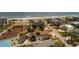 Aerial view of a two-story home with a pool and lush landscaping close to the beach at 113 Avalon Dr, Ormond Beach, FL 32176