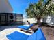 Backyard retreat featuring a screened-in pool, patio with lounge chairs, and lush landscaping for privacy at 113 Avalon Dr, Ormond Beach, FL 32176